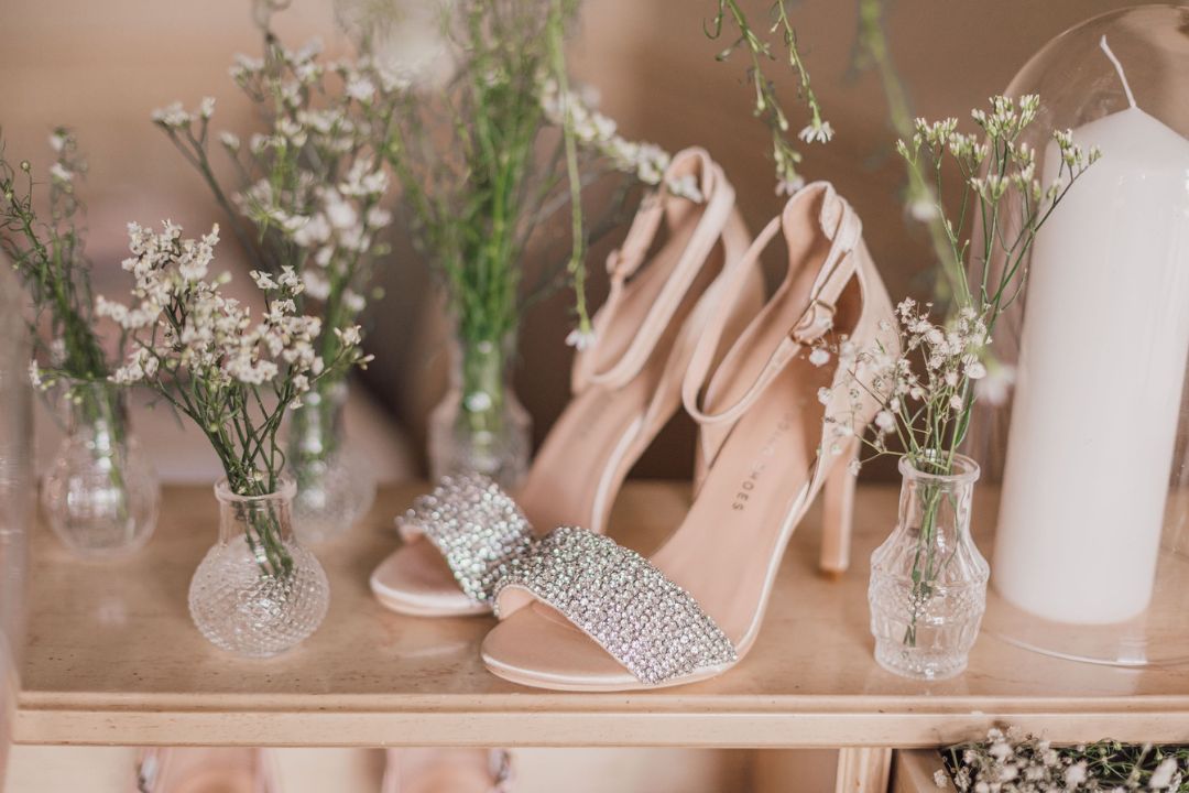 diamond studded sandals with flower at the background