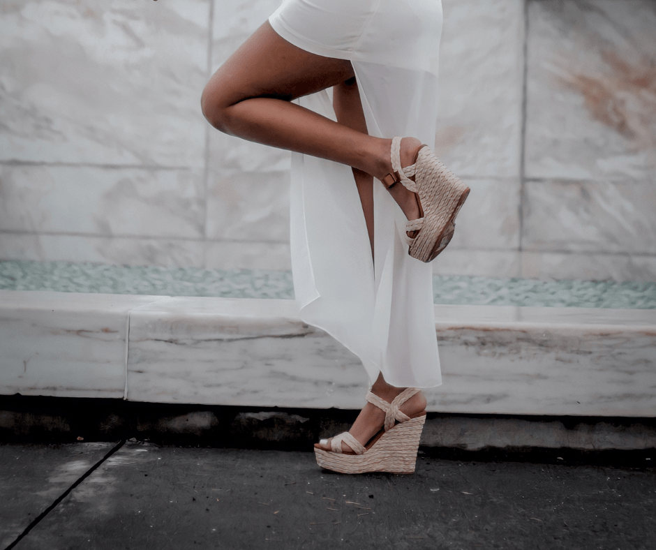 women posing on a road wearing wedge heel sandals